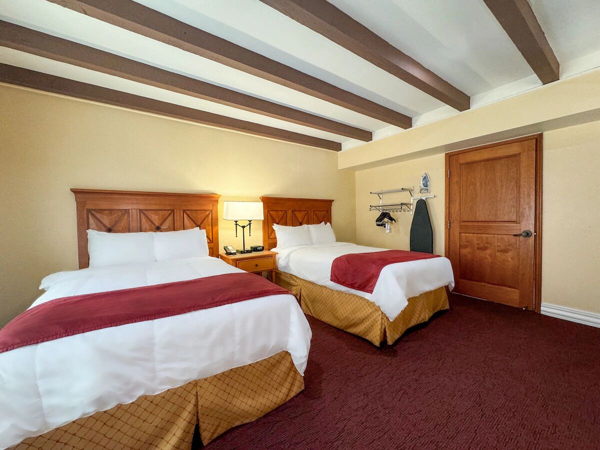 Settle into cozy double beds under warm wooden beams.
