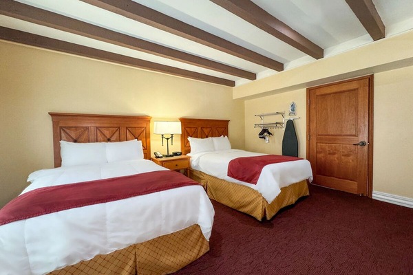 Settle into cozy double beds under warm wooden beams.