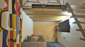A room with a loft bed, a brick wall, and a staircase. - Loft Alessandra Brera Design Hideaway (Milan)