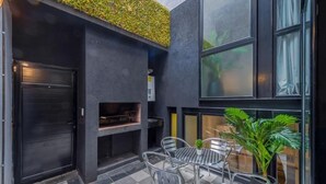 A modern outdoor seating area with a checkered floor, metal chairs, and a table. - MOT Honduras 5766 (Buenos Aires)