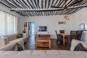 Deluxe Villa, Balcony, Pool View | Living area | 43-inch Smart TV with digital channels, Netflix, streaming services - AUREGI VILLAS (Diani Beach)