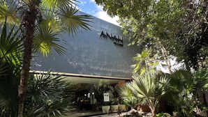 A modern building with a sign reading "ANAH." - Luxury Condo in PGA Golf Resort | Bahia Principe (Akumal)