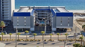 A hotel with a central atrium, multiple balconies, and a view of the ocean. - NEW LISTING!! Regatta Condos 304C - Beachfront Resort w/Pool (Gulf Shores)