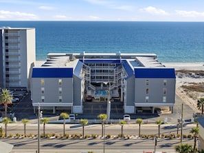 A hotel with a central atrium, multiple balconies, and a view of the ocean. - NEW LISTING!! Regatta Condos 304C - Beachfront Resort w/Pool (Gulf Shores)
