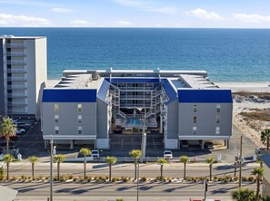 A hotel with a central atrium, multiple balconies, and a view of the ocean. - NEW Rental!!! Regatta Condos 201A - Full Beach View with Gulf Front Resort!! (Gulf Shores)