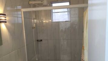 Chuveiro, toalhas de banho, sabonete, shampoo