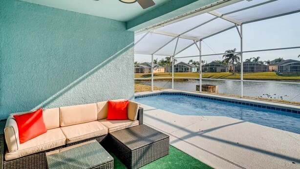 A poolside area with a sofa and a ceiling fan. -     Family Pool Home-Near Disney, Food Festivals & Events- Book Now (Davenport)