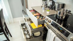 A modern kitchen with a built-in oven, a coffee maker, and a kettle. -     Family Pool Home-Near Disney, Food Festivals & Events- Book Now (Davenport)