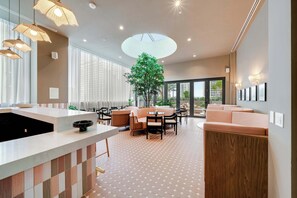 A modern interior with a kitchen area, seating, and a large window. - Urban Oasis Luxury Suite- Sky High Amenities (Miami)
