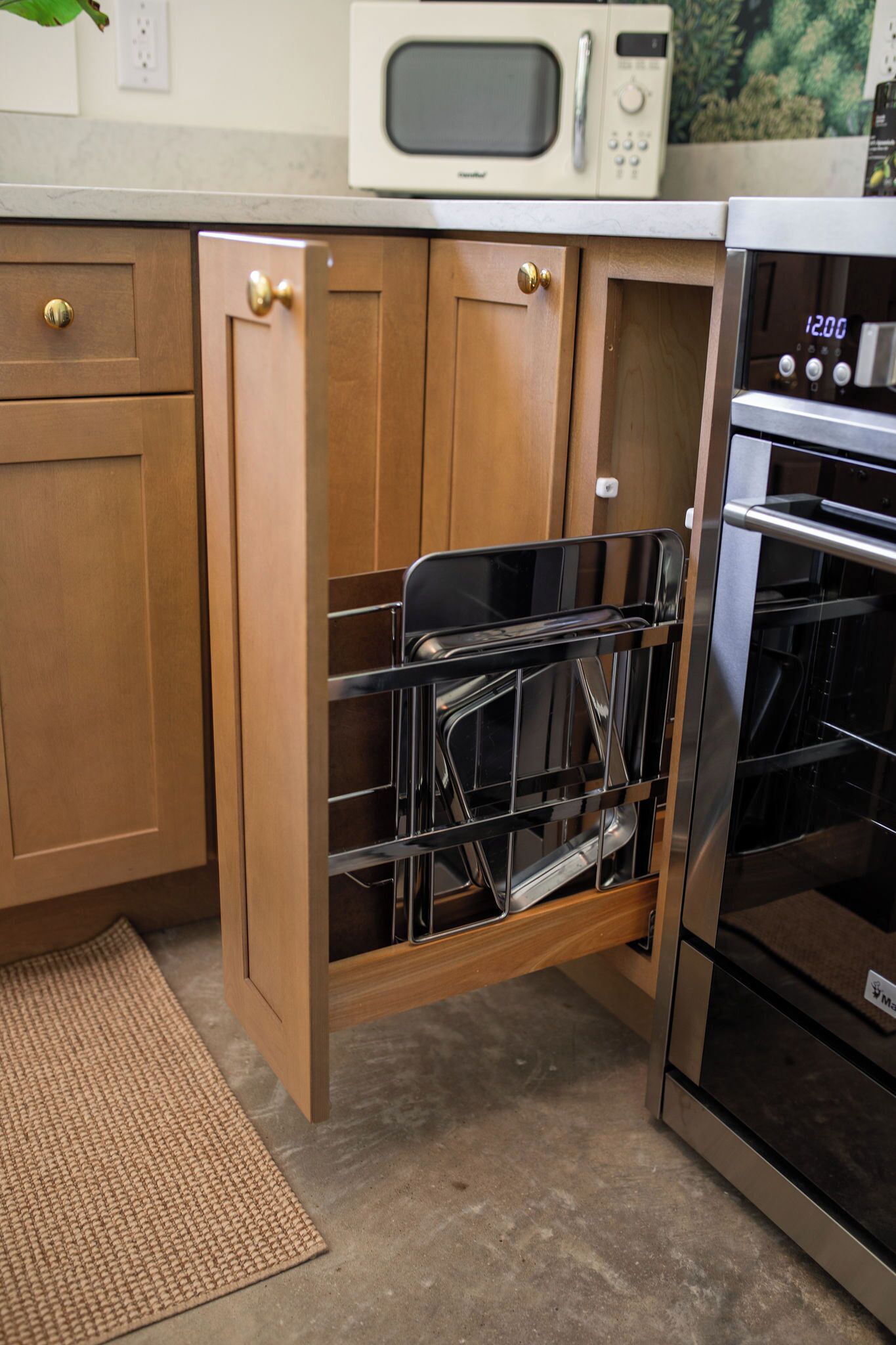 A kitchen with wooden cabinets, a built-in dishwasher, a microwave, and an oven.