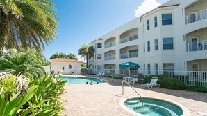 A hotel with a pool area, outdoor seating, and a building with balconies. - Villas Of Ocean Gate II with Ocean View (St. Augustine)