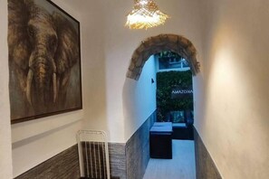 A hallway with a stone archway leading to a room labeled "AMAZONIA." - Amazon Jacuzzi Relax in the Heart of the Harbor (El Puerto de Santa María)