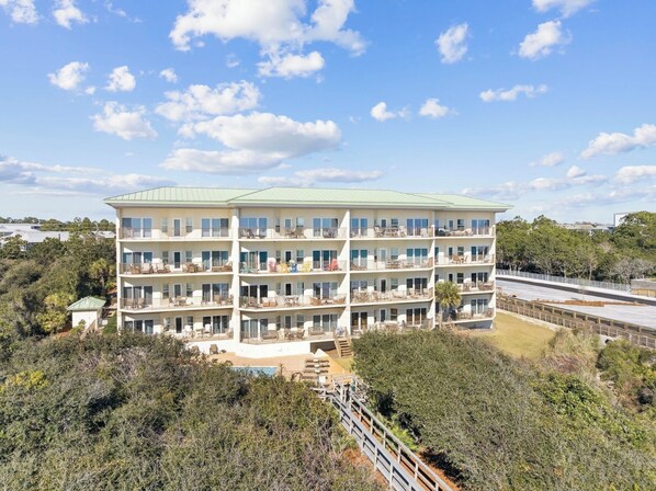 A multi-story hotel with balconies, a flat roof, and a view of the surrounding landscape. - Gulf-Front Condo w/ Pool and Beach Access (Santa Rosa Beach)