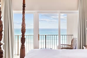 A bedroom with a large bed, a view of the ocean, and a balcony with a chair. - Gulf-Front Condo w/ Pool and Beach Access (Santa Rosa Beach)