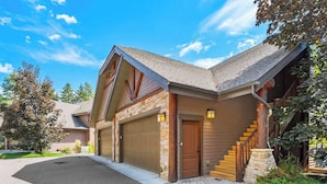 A two-story house with a garage, a staircase, and a well-maintained lawn. - Flathead Lodge | Close to Skiing & Glacier Park (Somers)