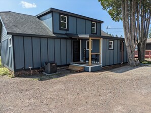 A two-story house with a front porch, a small deck, and a welcome sign. - Cozy two bedroom bungalow (Duluth)
