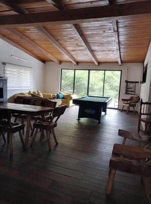 A spacious room with a dining table, chairs, a pool table, and a sofa. - CABERNET CABANA CABERNET PINOS DEL RIO NEXT TO UMA CACHOEIRA (Mazamitla)