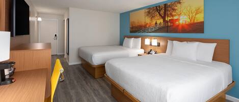 A hotel room with two beds, a desk, a chair, a painting, and a TV.