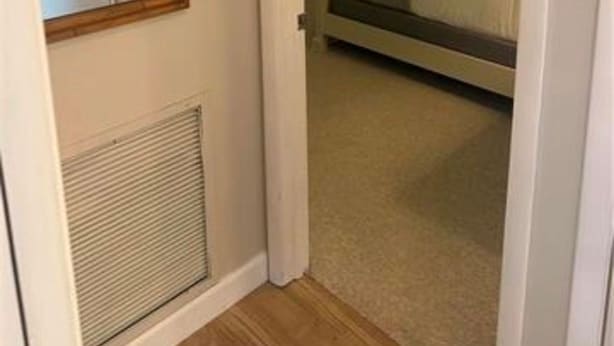 A bedroom with a bed, a dresser, and a ceiling fan. - The Blue Retreat in Fort Myers Beach (Fort Myers Beach)