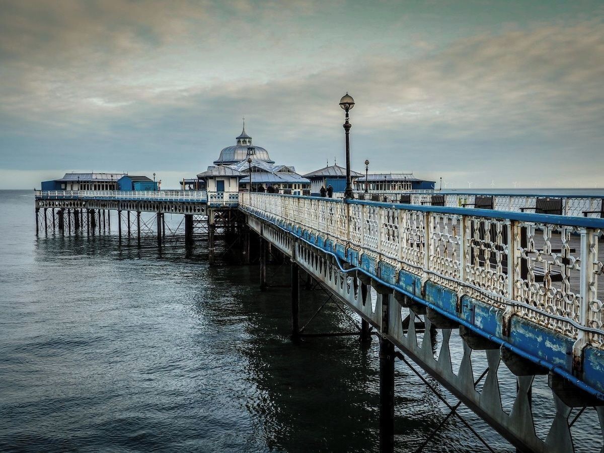 A pier with a domed structure and a lamp post.