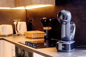 A modern kitchen with a coffee machine, a toaster, and a knife set on the counter. - James Court Llandudno Luxury Apartment 2 & Parking (Llandudno)