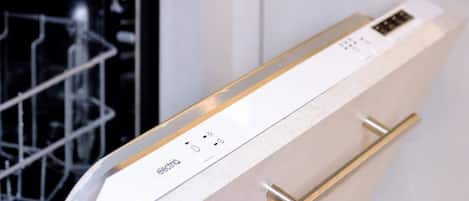 A dishwasher with a control panel and a metal rack above it.