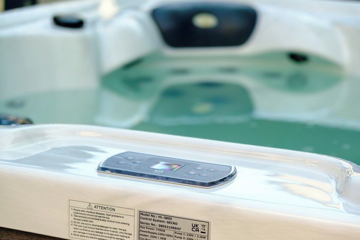 A spa tub with a control panel and safety instructions.