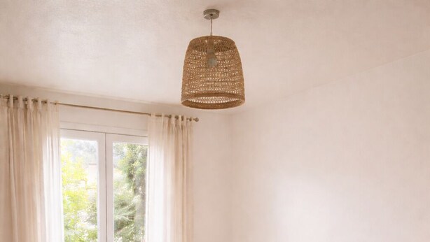 A bedroom with a wooden bed, a nightstand, a lamp, and a window with curtains. - Family villa in the heart of the Vaucluse (Sorgues)