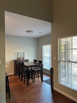 A dining area with a wooden table and chairs, a bar sign, and a window with blinds. - Master’s Rental - 2 weeks 3 bed/2bath - 3 miles from golf course Augusta, GA (Augusta)
