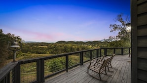 A wooden deck with a railing, overlooking a forested landscape with hills in the distance. - High Top: AMAZING views on a private 100 acres within city limits: EXCLUSIVE! (Sevierville)