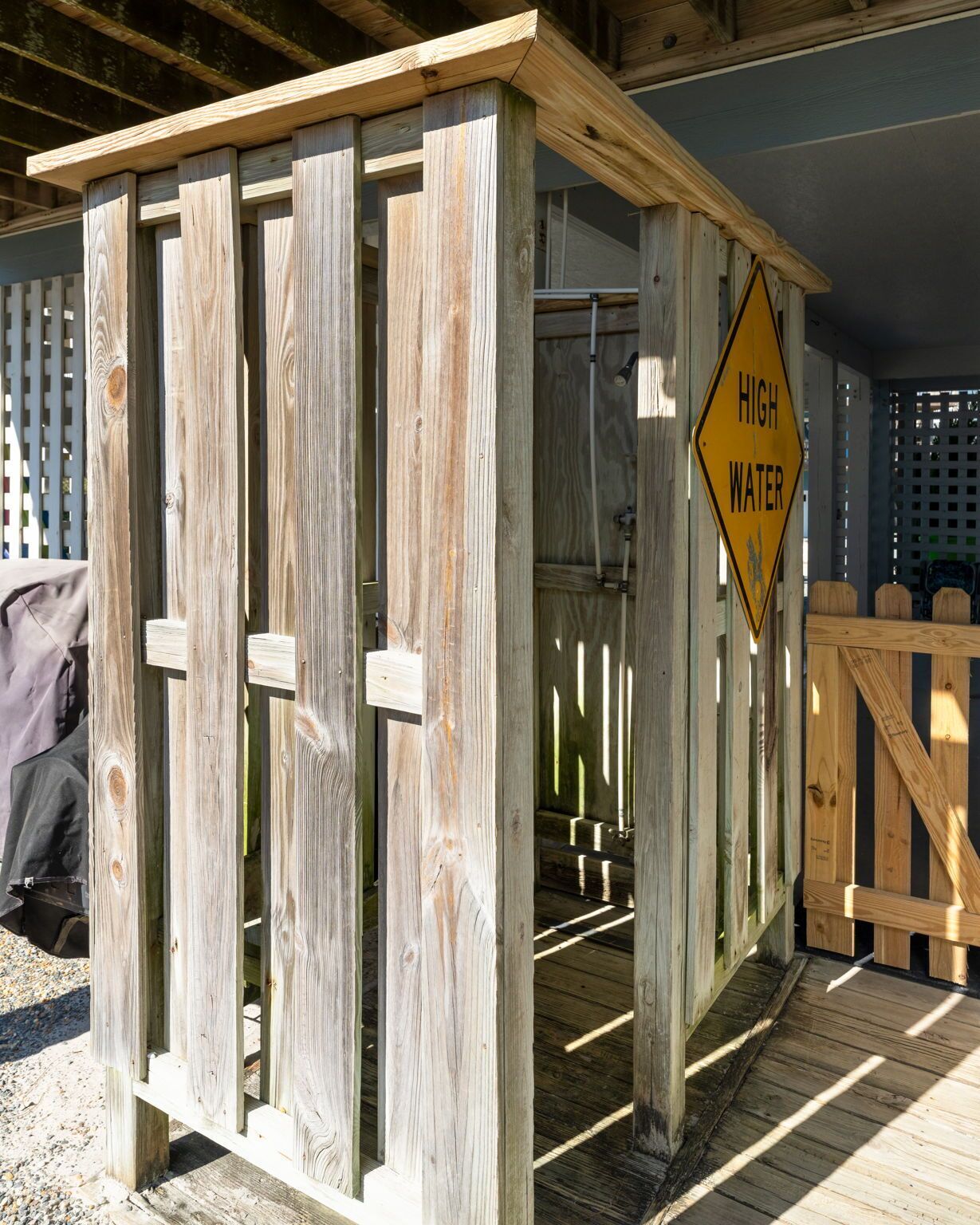 A wooden structure with a 'High Water' warning sign.