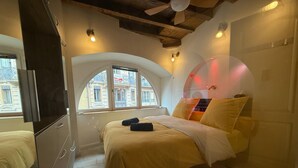 A bedroom with a bed, a wardrobe, a window, and a ceiling fan. - A jewel in TOULOUSE (Toulouse)