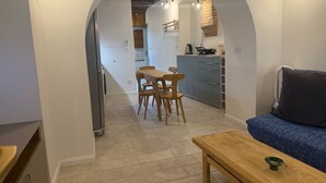 A compact living space with a dining area, kitchenette, and a sofa. - A jewel in TOULOUSE (Toulouse)
