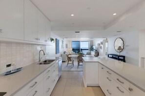 Bright, spacious kitchen flowing into cozy dining and living areas - Beachplace 8-305 by FGC (Longboat Key)