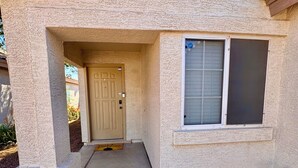 A house with a concrete entrance, a door, and a window with blinds. - new listing (Phoenix)