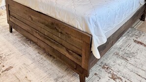 A bedroom with a wooden bed frame, a white bedspread, and a headboard. - new listing (Phoenix)