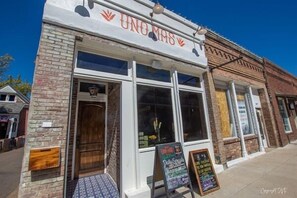 A building with a sign reading "UNO MAS" and a chalkboard menu outside. - "Sippin on Savannah Square" by OVR (Oxford)