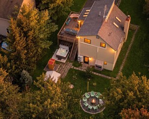 A two-story house with a deck, a hot tub, and a fire pit. - Poconos Retreat: Theater, Hot Tub, Sauna, Games (Tobyhanna)