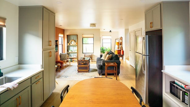 A spacious kitchen with a dining area, a refrigerator, and a microwave.