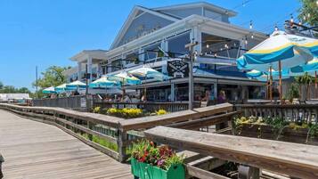 A waterfront restaurant with outdoor seating, a wooden deck, and a sign indicating a beer garden.
