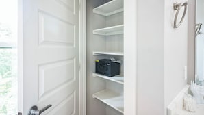 A bathroom with a white door, a towel ring, and a mirror. - 3-bedroom house in nice Houston with cool AC for relaxing stay (Houston)