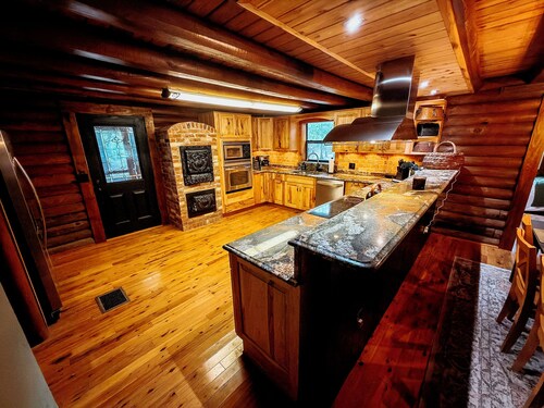 Gorgeous and peaceful 4-bedroom cabin with wooded landscape and gated entry.