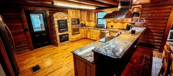 Gorgeous and peaceful 4-bedroom cabin with wooded landscape and gated entry.
