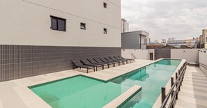 A rooftop swimming pool with lounge chairs and a tiled wall. - Sambadrome | Allianz Parque | Expo Center Norte | Bom Retiro. (São Paulo)