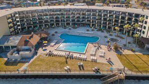 Un hotel con piscina, mobiliario exterior y vistas del entorno.