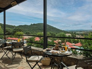 Zona pranzo all'aperto con terrazza affacciata su un paesaggio suggestivo.