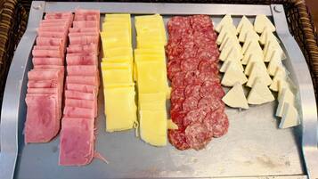 Una variedad de carnes y quesos en una bandeja.