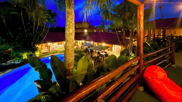 Ein Resort mit Pool, Sitzgelegenheiten im Freien und einer Holzterrasse.