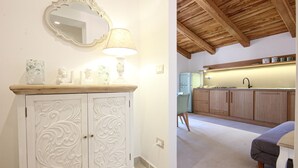 A white cabinet with ornate carvings, a mirror, and a lamp. - Gorgeous apartment in San Marco di Castellab (San Marco di Castellab)