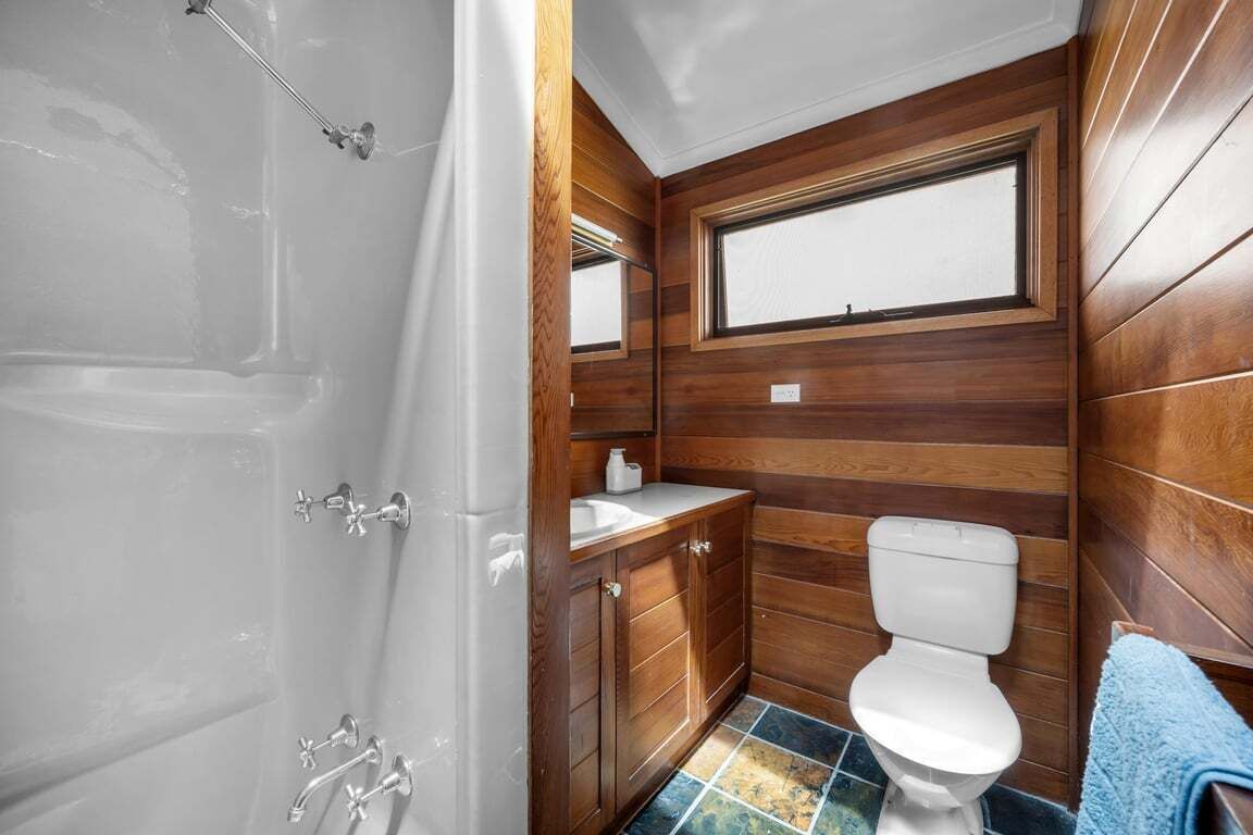 A compact bathroom with a bathtub, a toilet, and a sink.